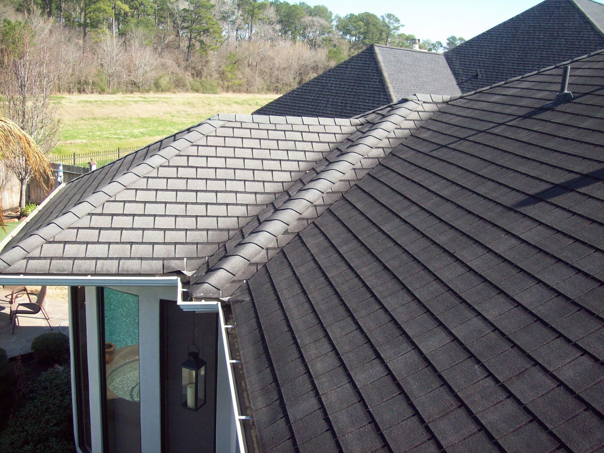 A house with a black roof and a white door
