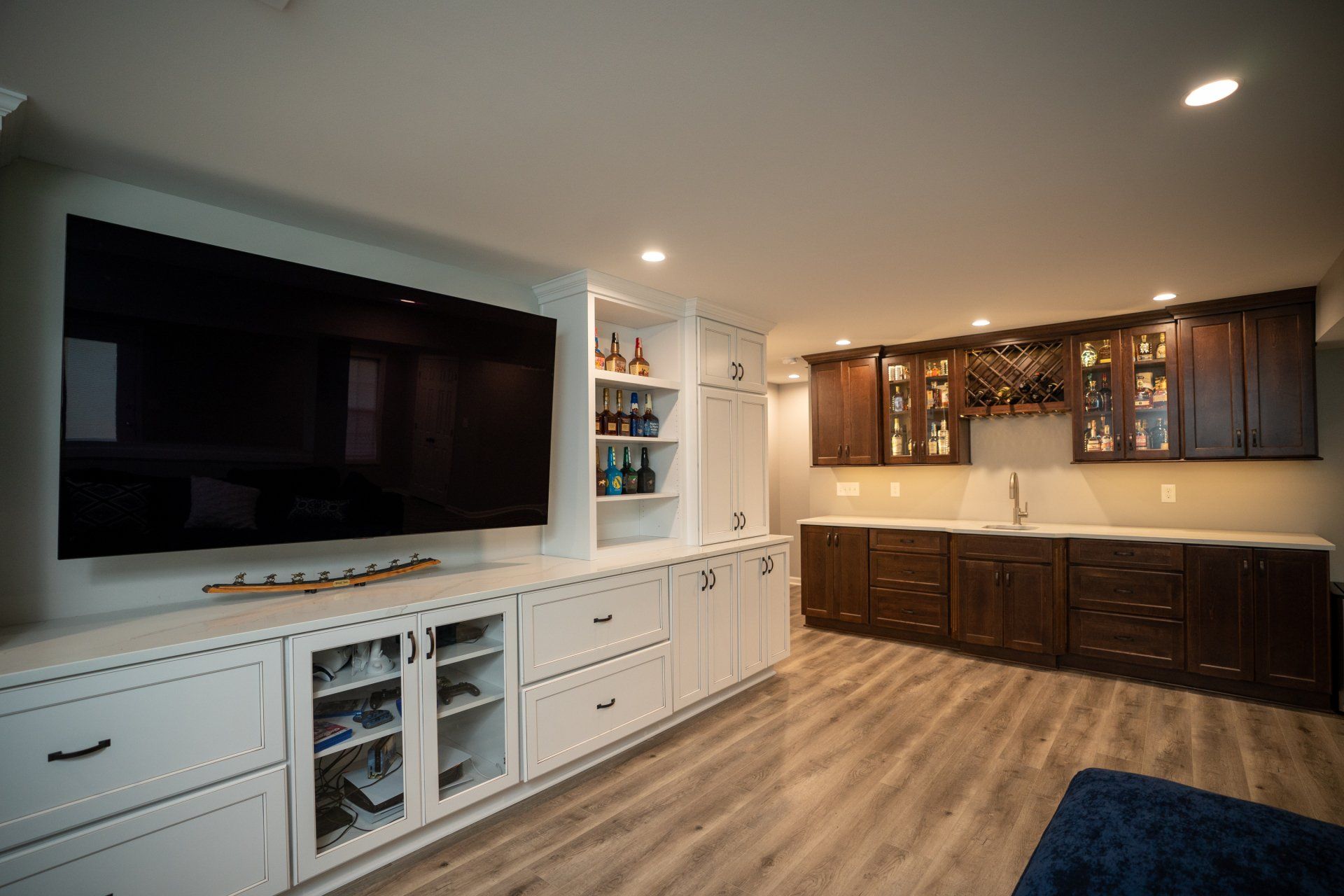A living room with a large flat screen tv on the wall.