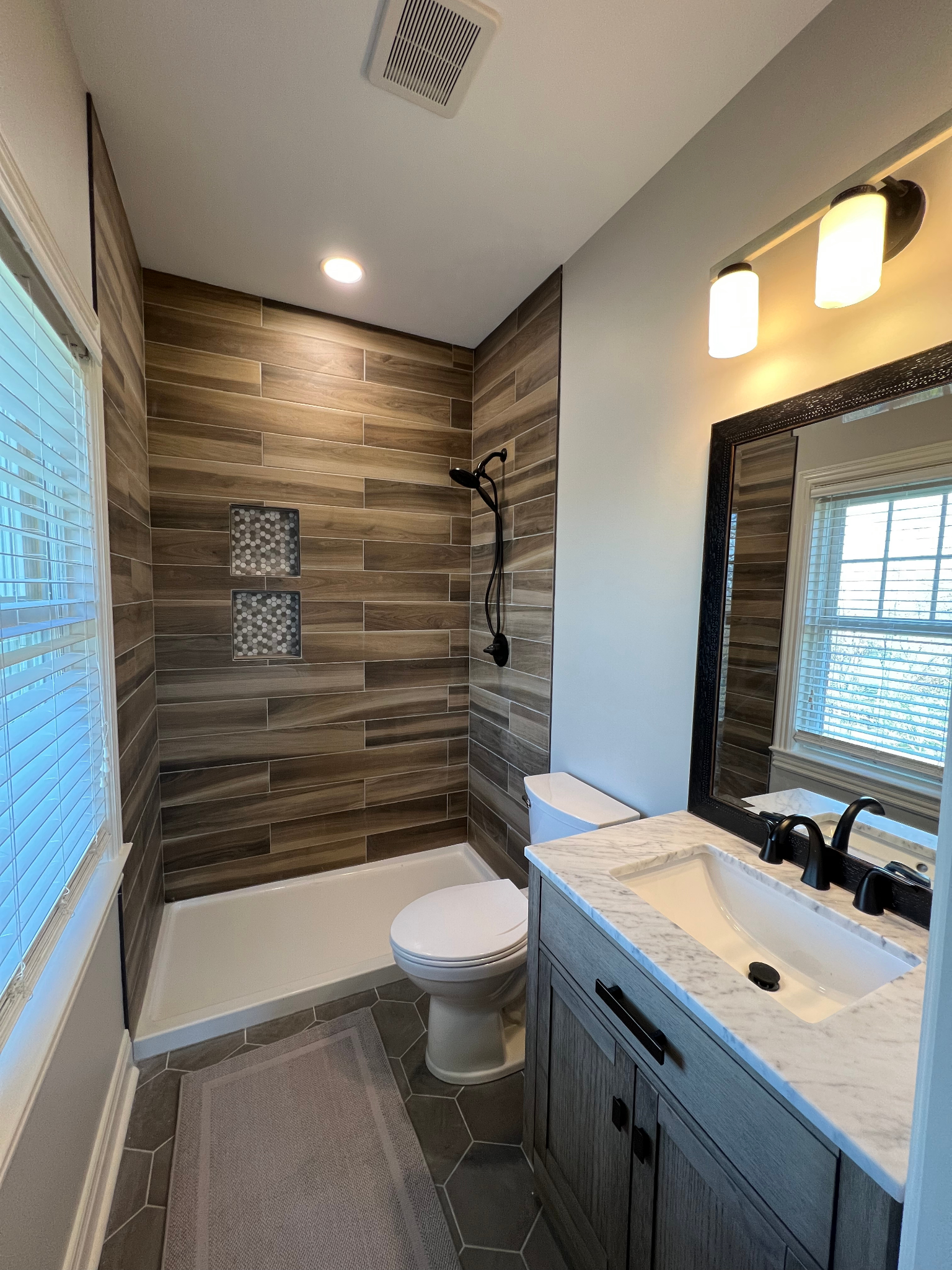 A bathroom with a toilet , sink , and shower.