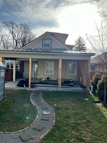 A house is being remodeled with a porch and a walkway.