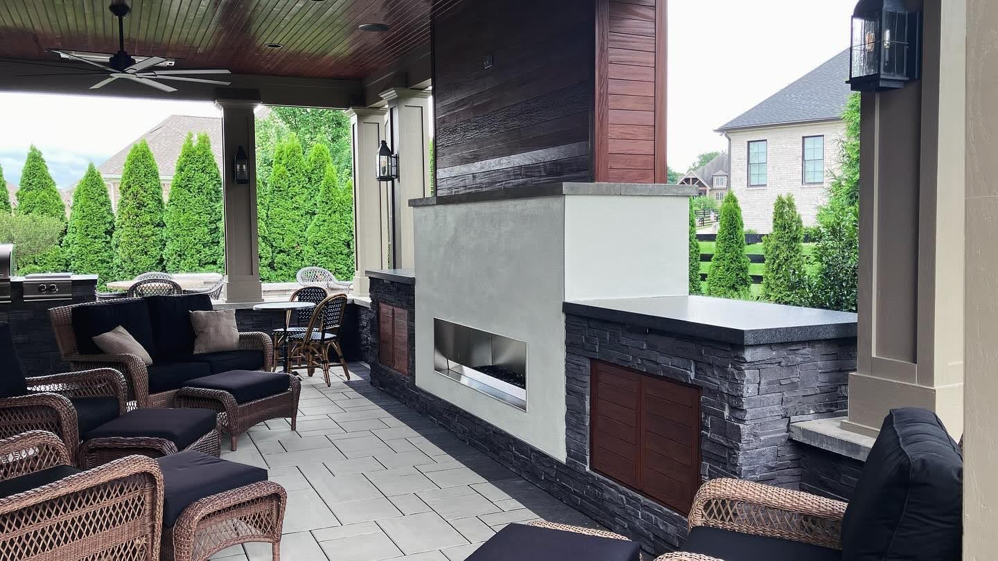 There is a fireplace in the middle of the patio.