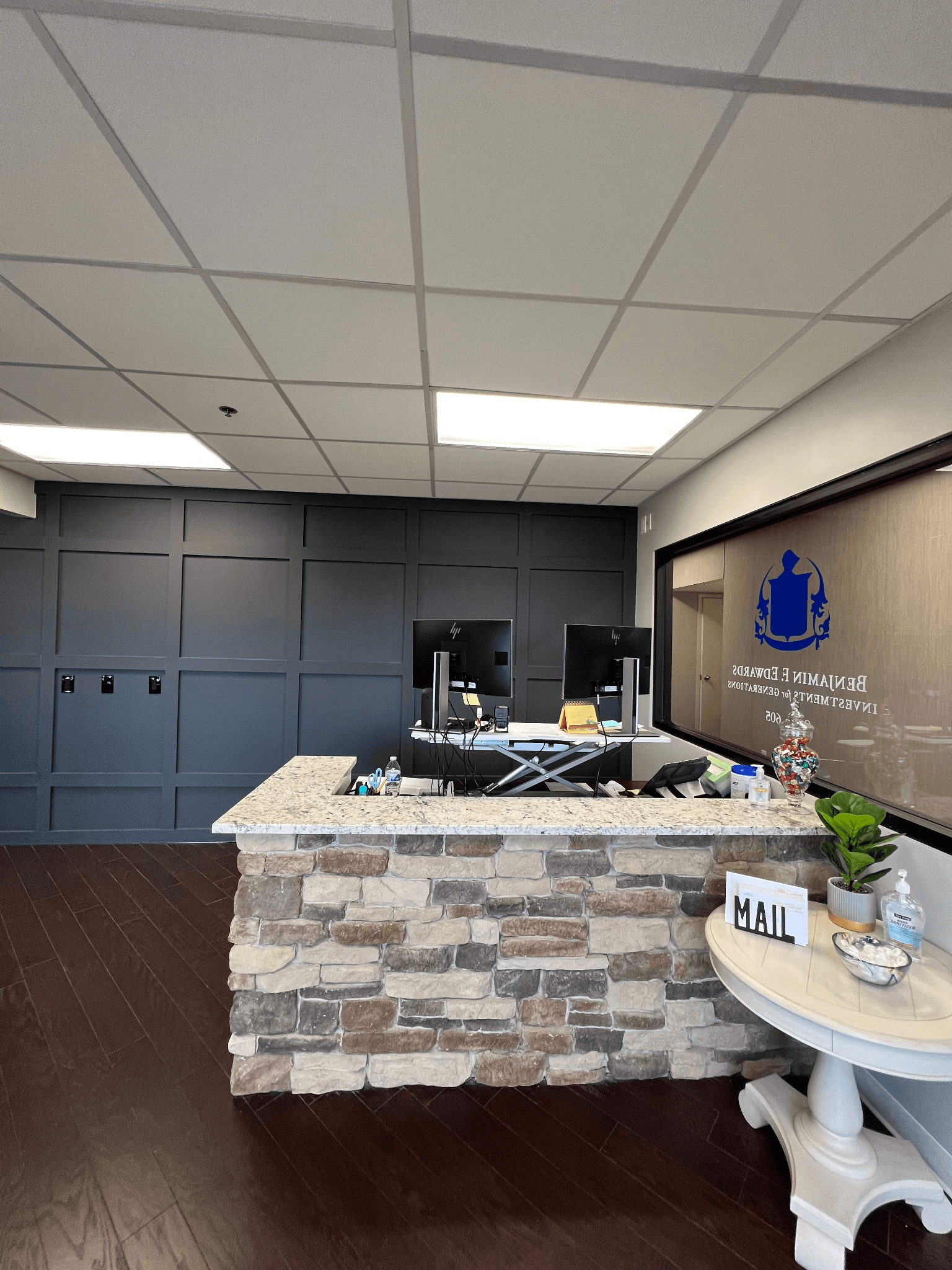 A reception area with a stone counter and a table