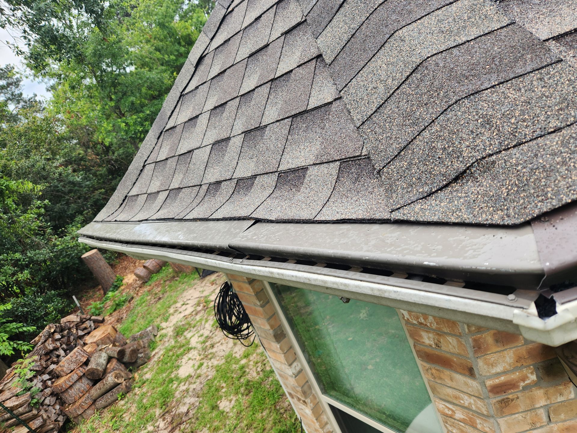 A house with a gutter on the side of it and a roof.