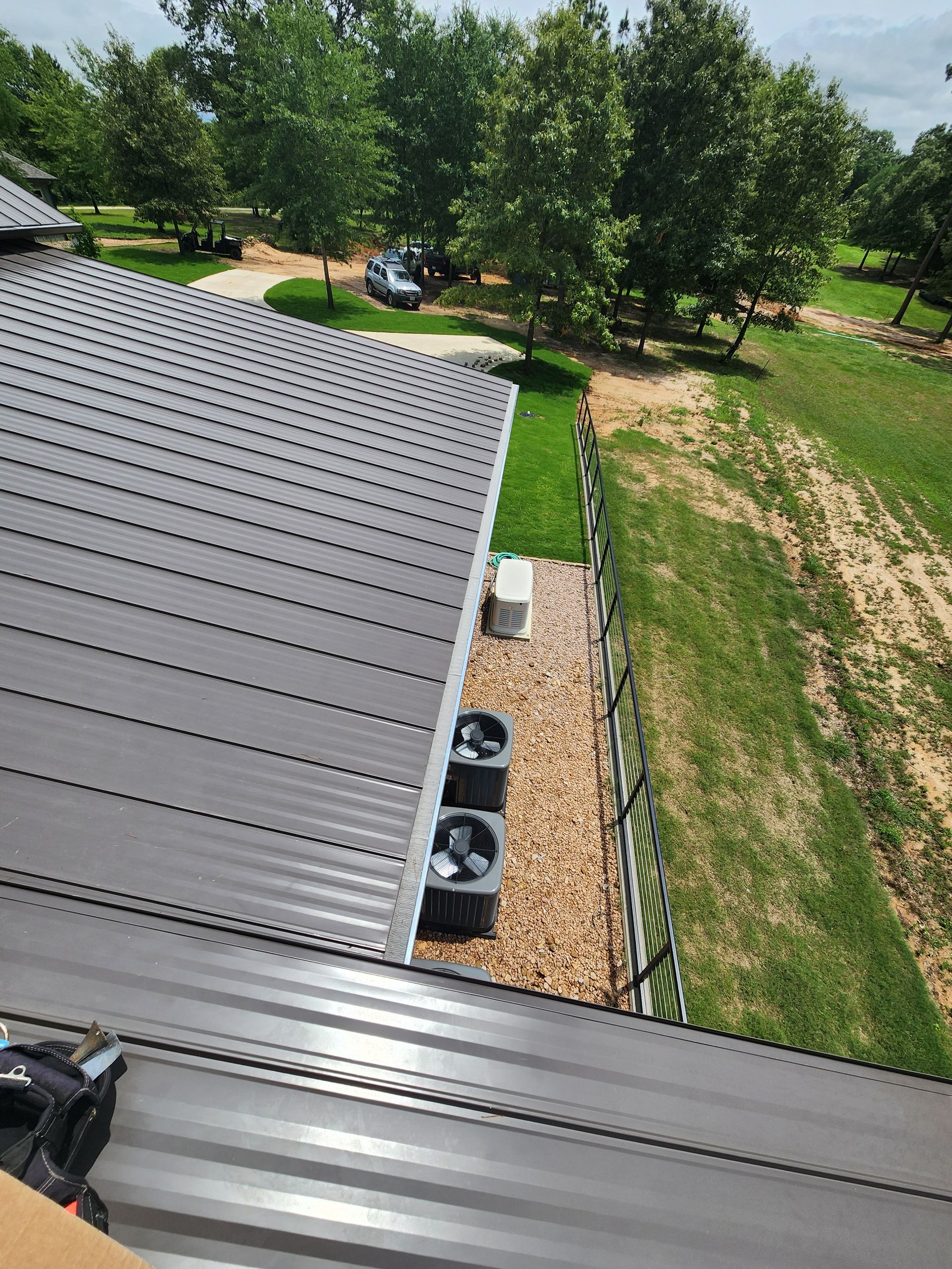 An aerial view of a roof with three air conditioners on it.