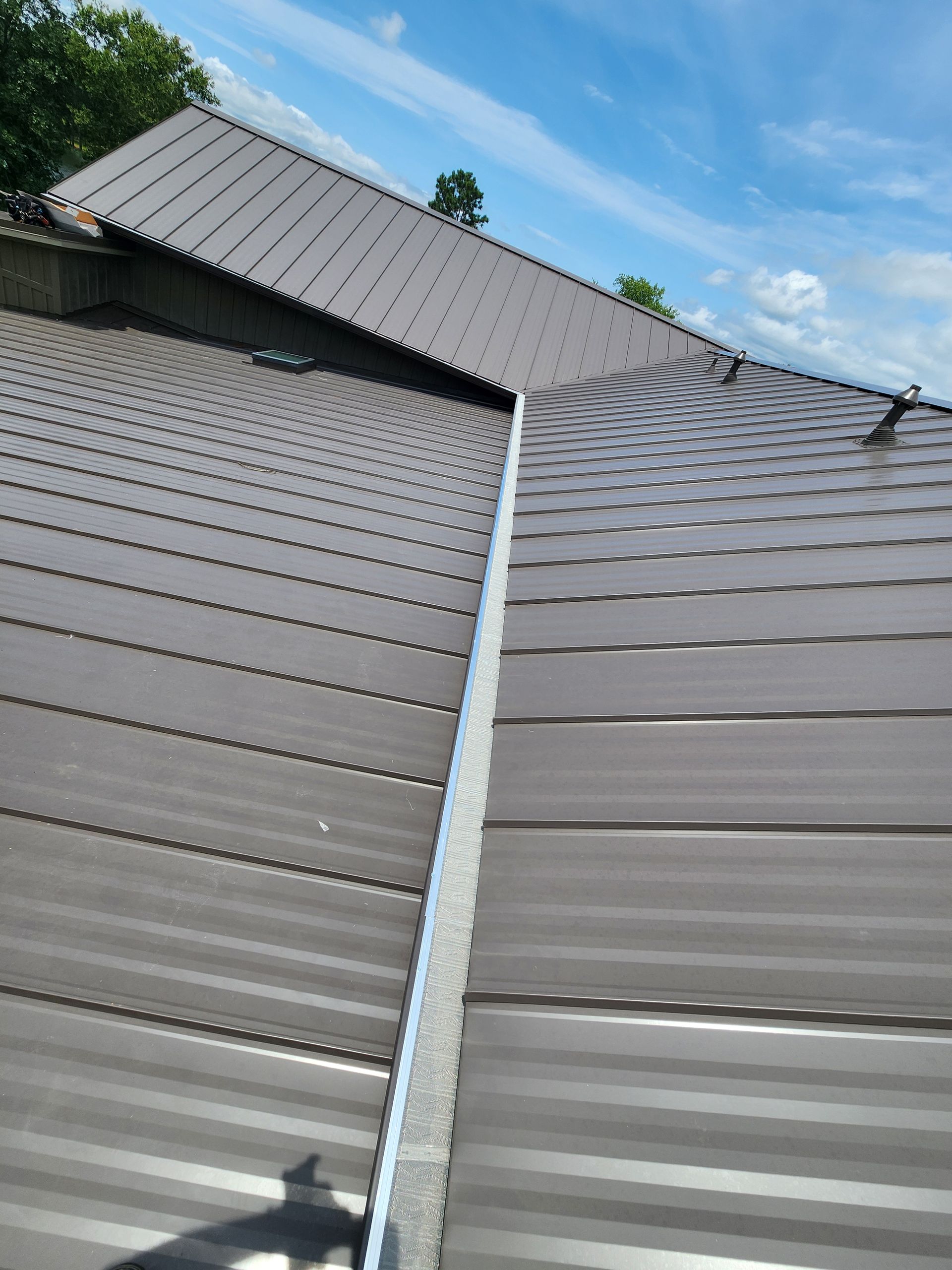 A close up of a roof with a blue sky in the background