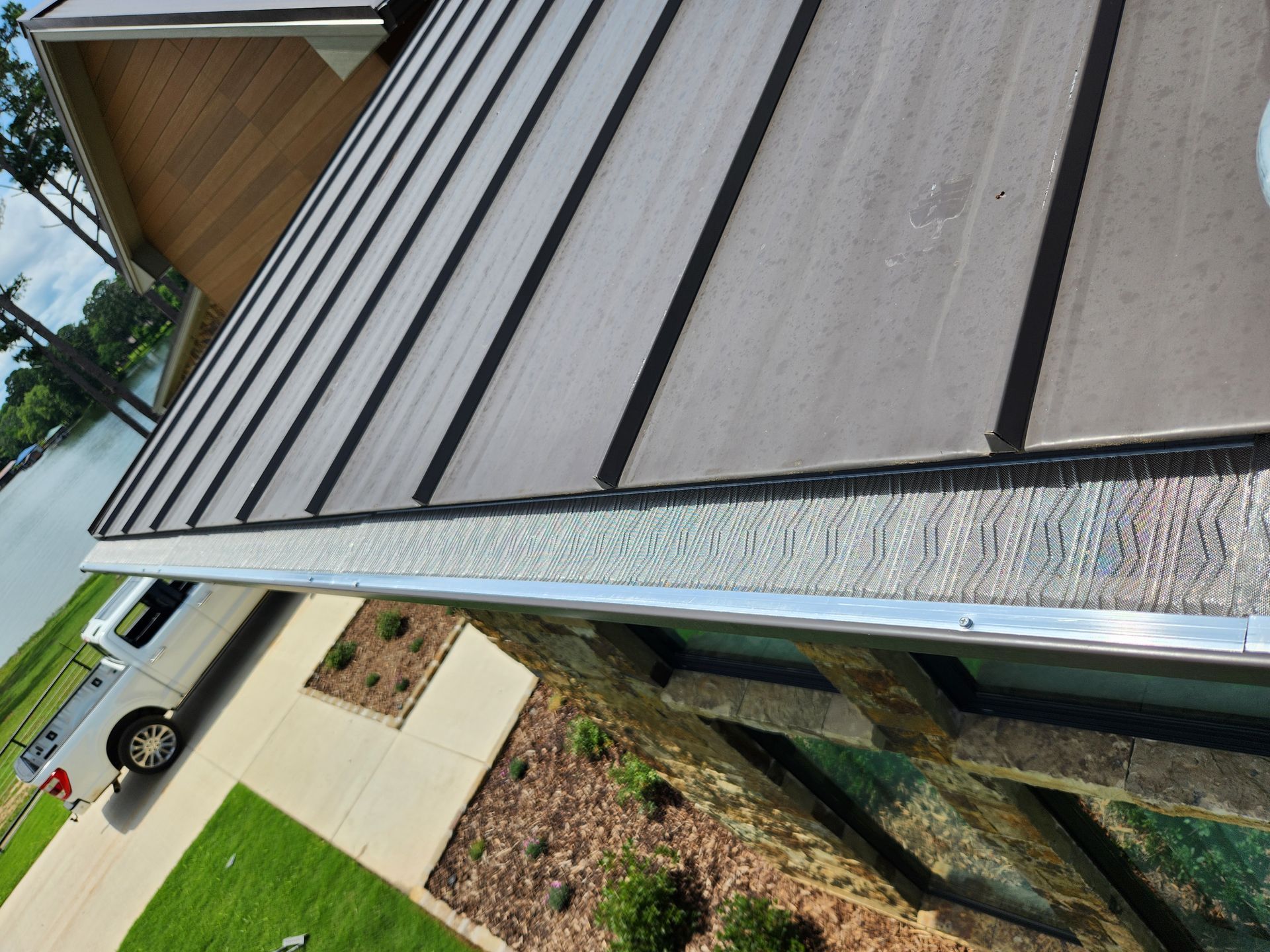 A car is parked on the side of the road next to a roof.