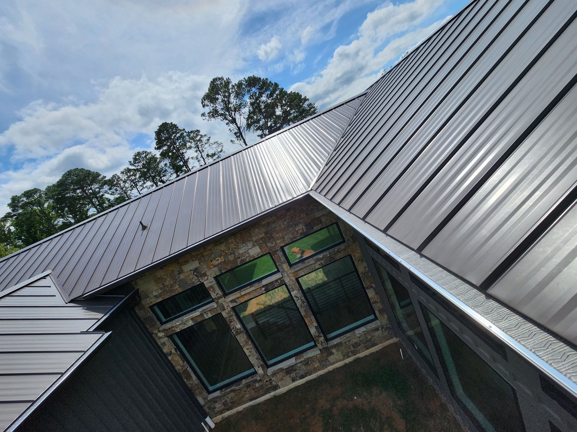 An aerial view of a house with a metal roof.