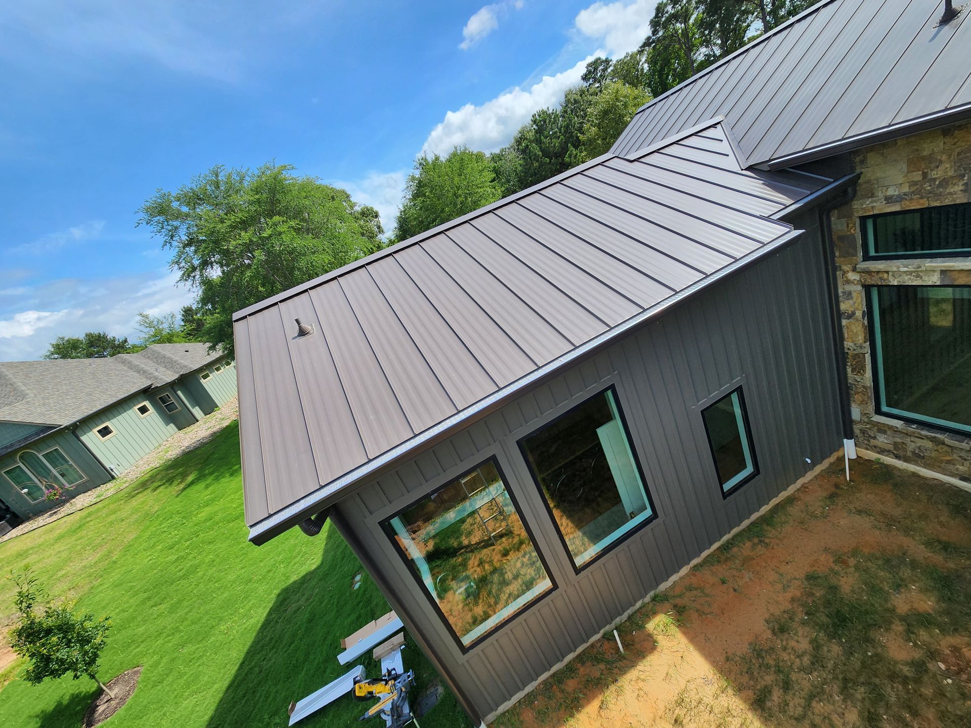 An aerial view of a house with a metal roof.