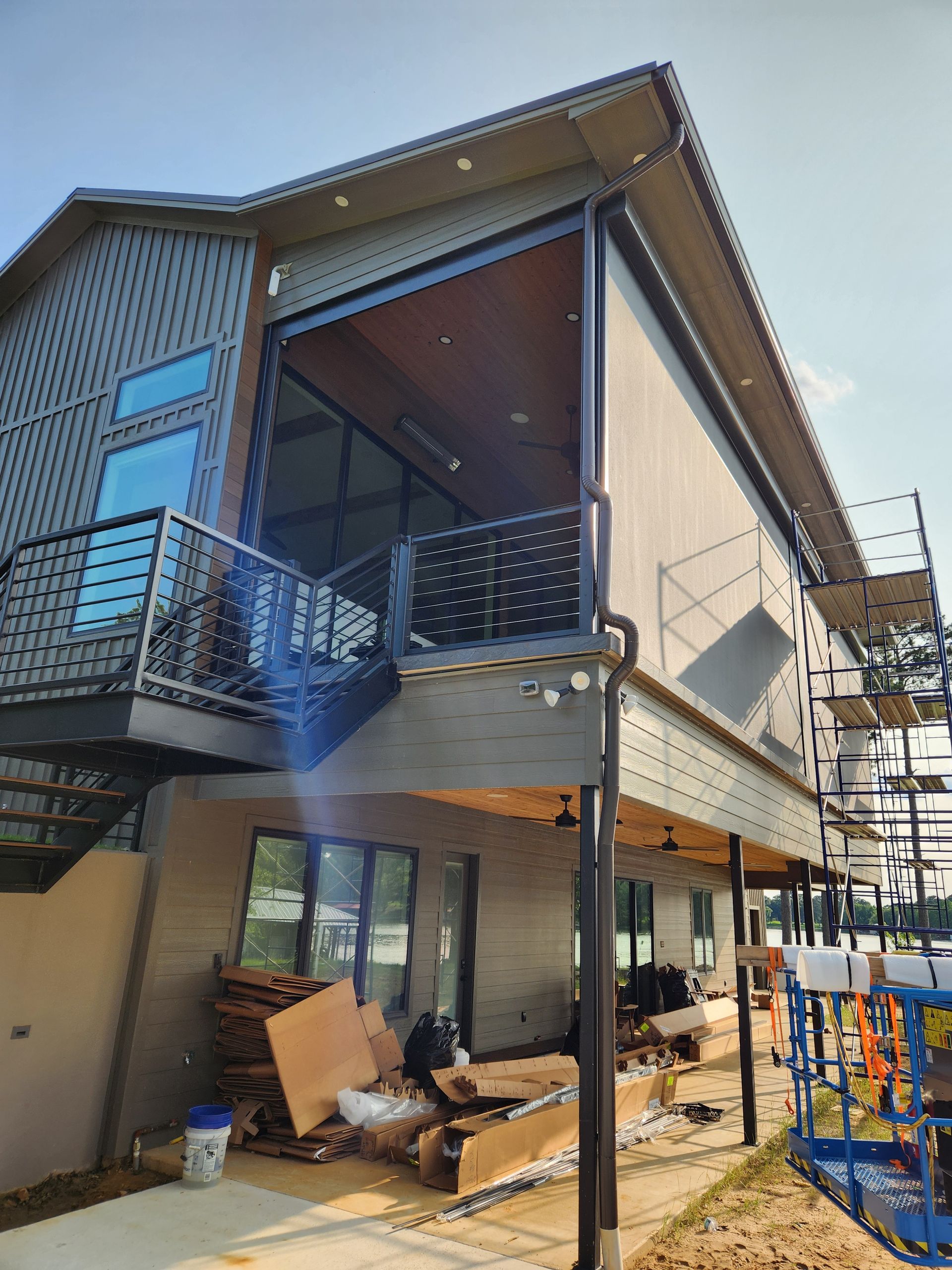A large house with a balcony and stairs is being built.