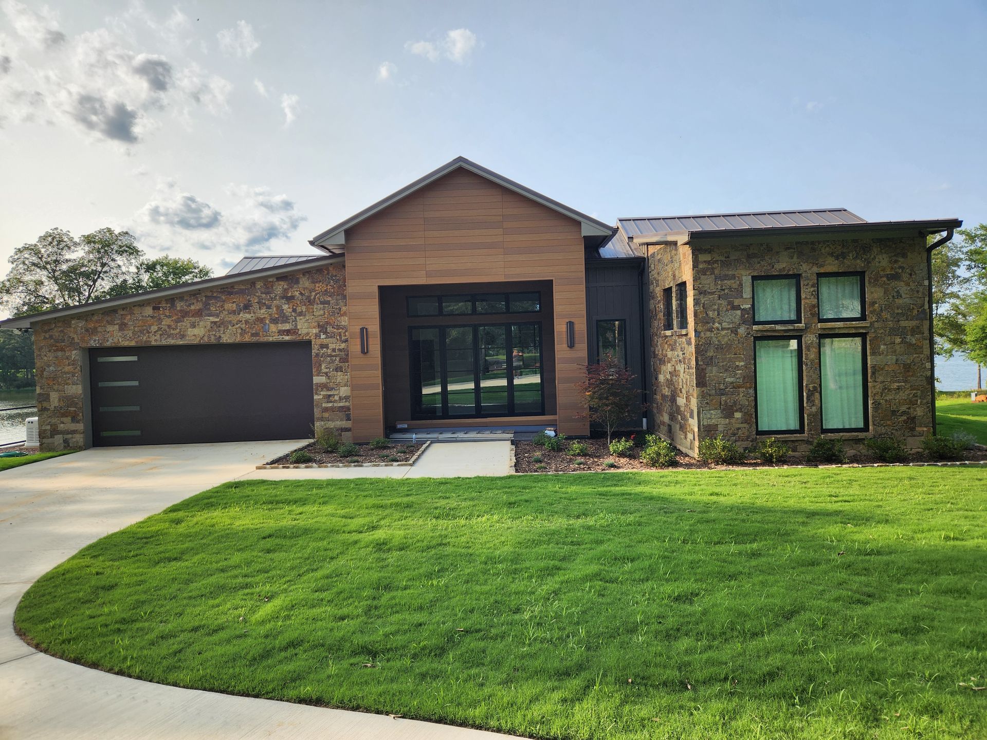 A modern house with a large lawn in front of it.