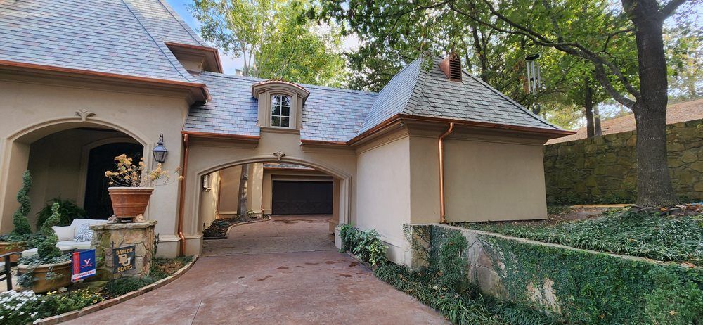A large house with a driveway leading to it and a garage.