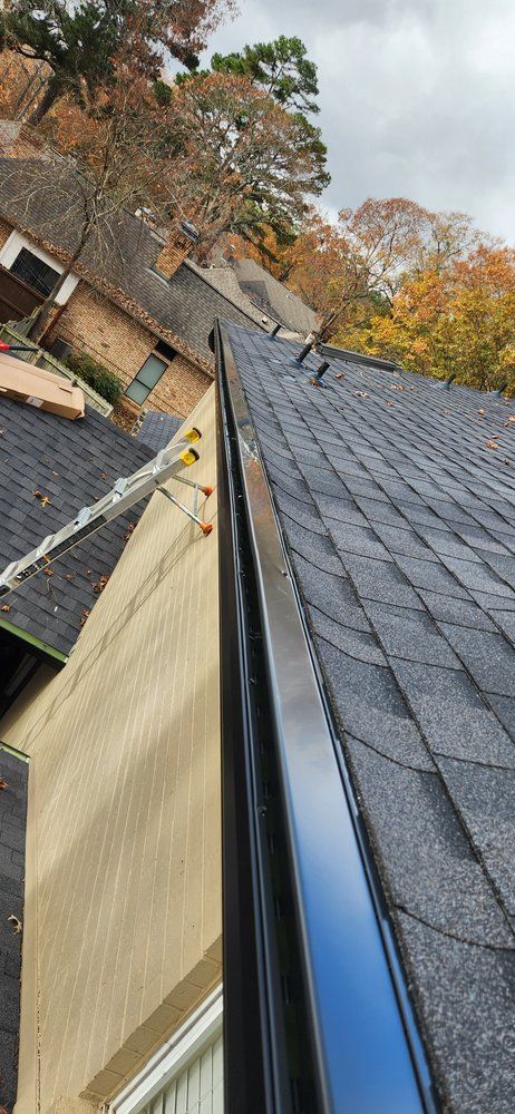 A close up of a gutter on a roof of a house.