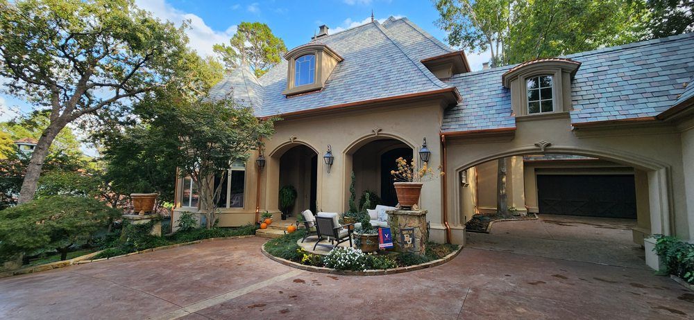 A large house with a garage and a driveway in front of it.