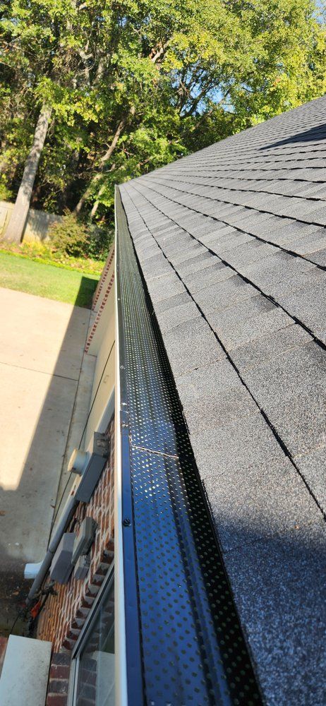 A close up of a gutter on the side of a house.