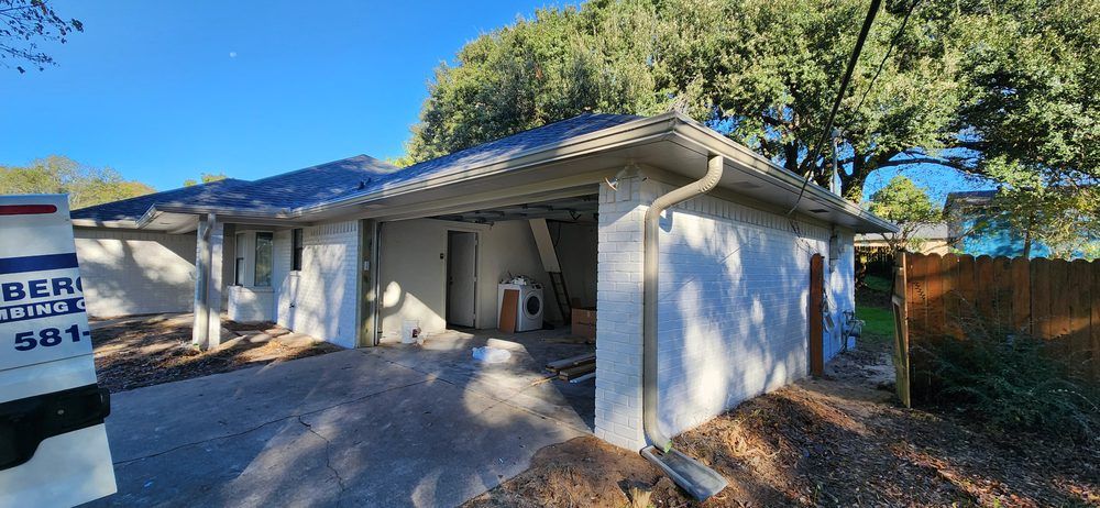 A white van is parked in front of a white house.