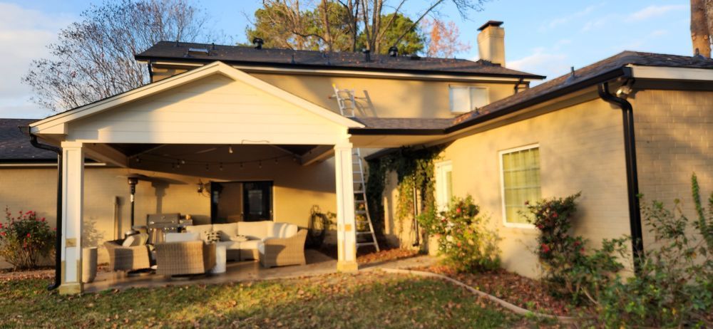 A large house with a covered patio in the backyard.