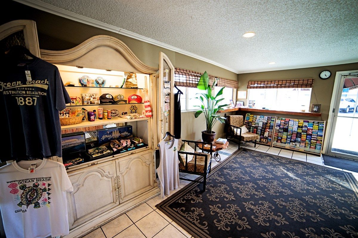 Gift shop interior with display cabinet, t-shirts, and brochures.