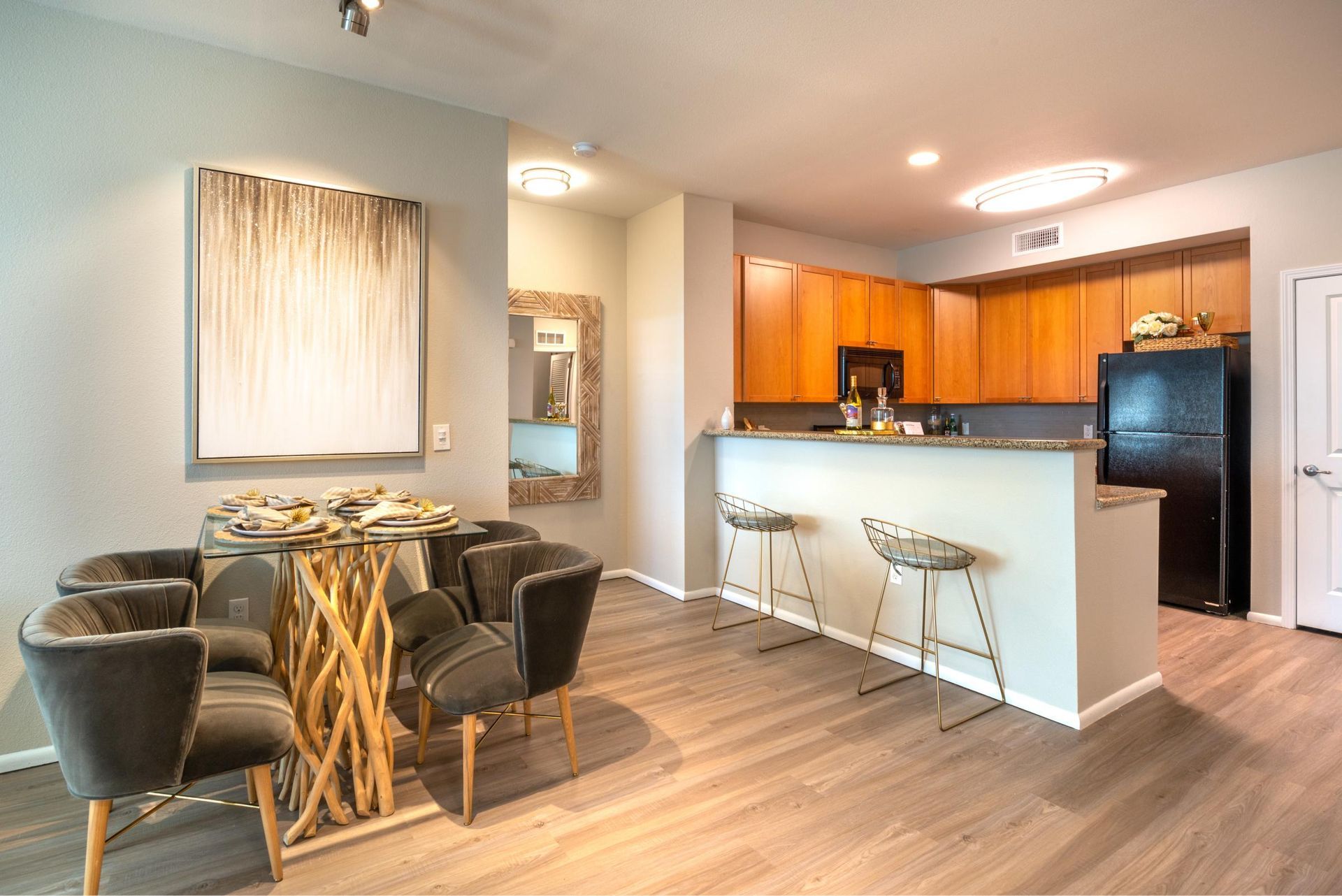 Open-concept kitchen and dining area with a breakfast bar and two stools.