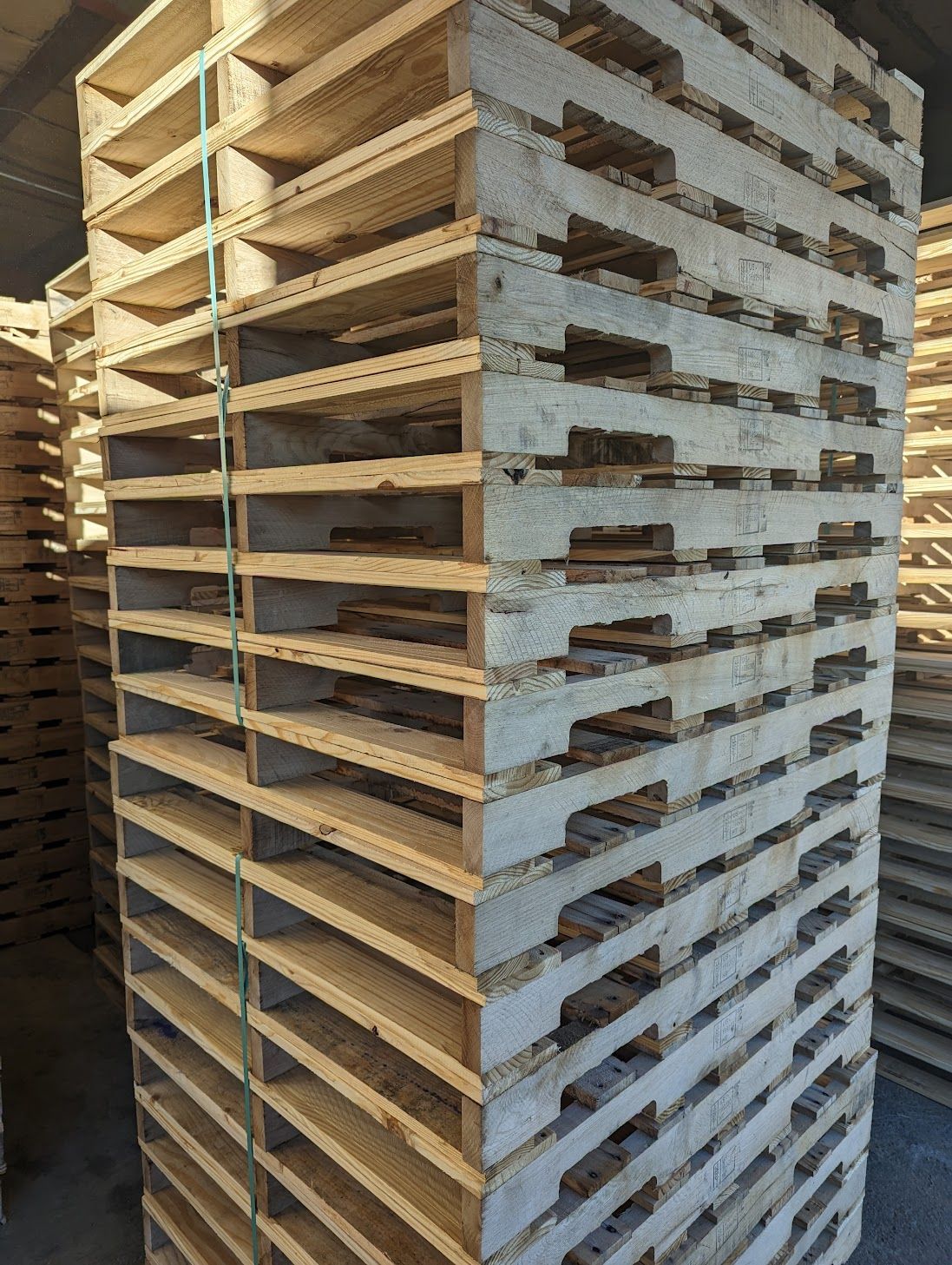 A pile of wooden pallets stacked on top of each other.