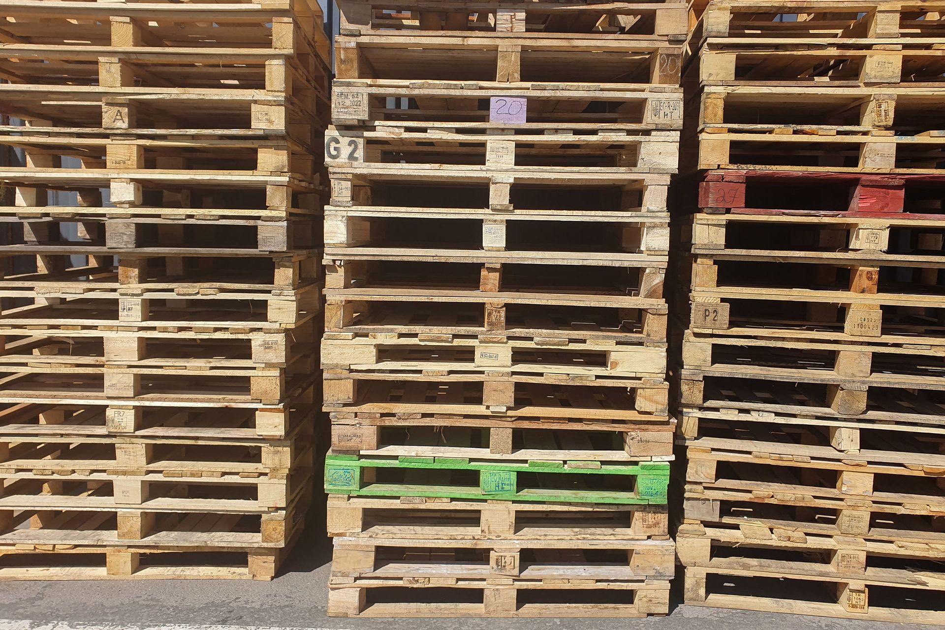 A bunch of wooden pallets are stacked on top of each other.