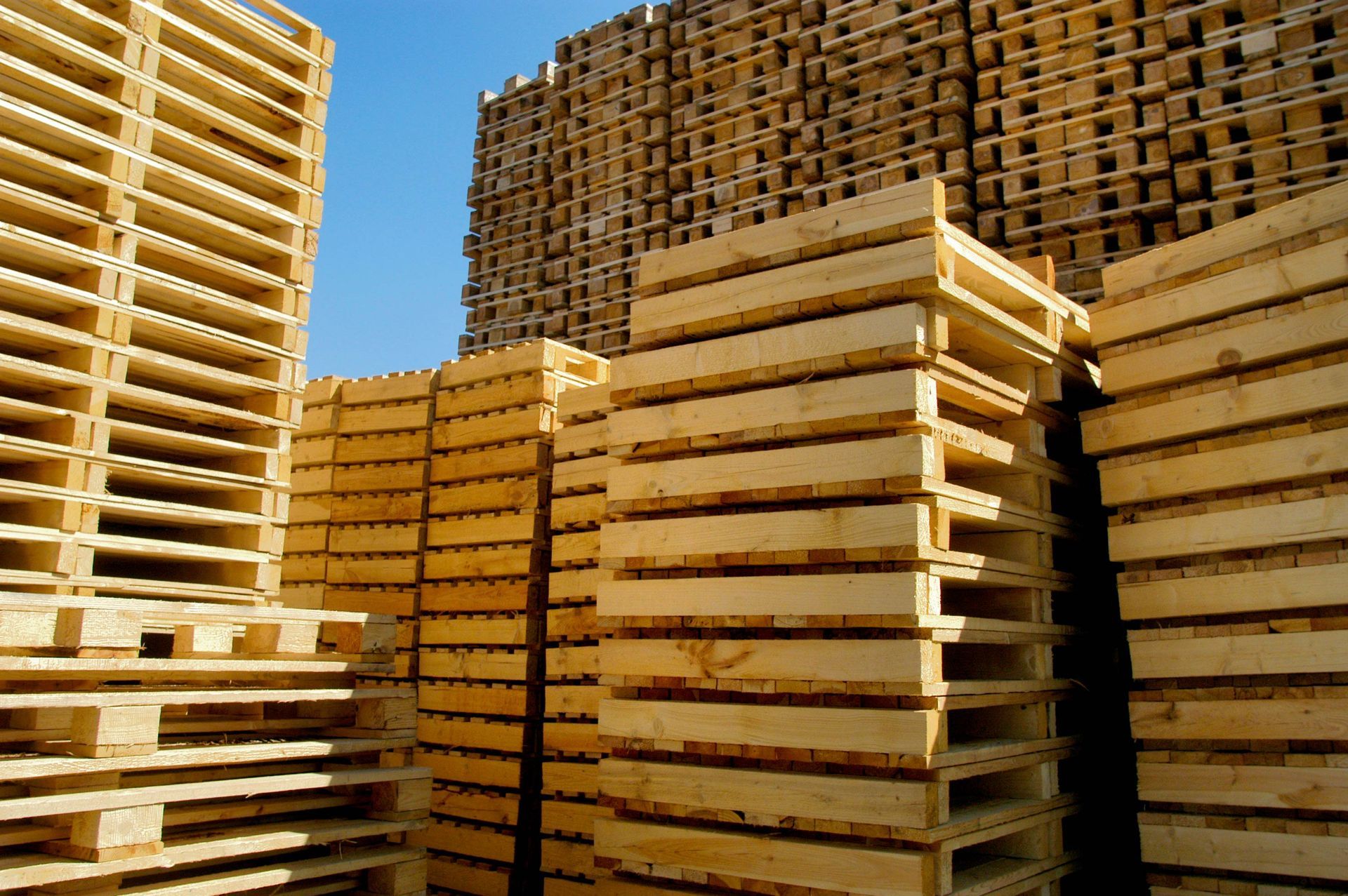 A pile of wooden pallets stacked on top of each other.