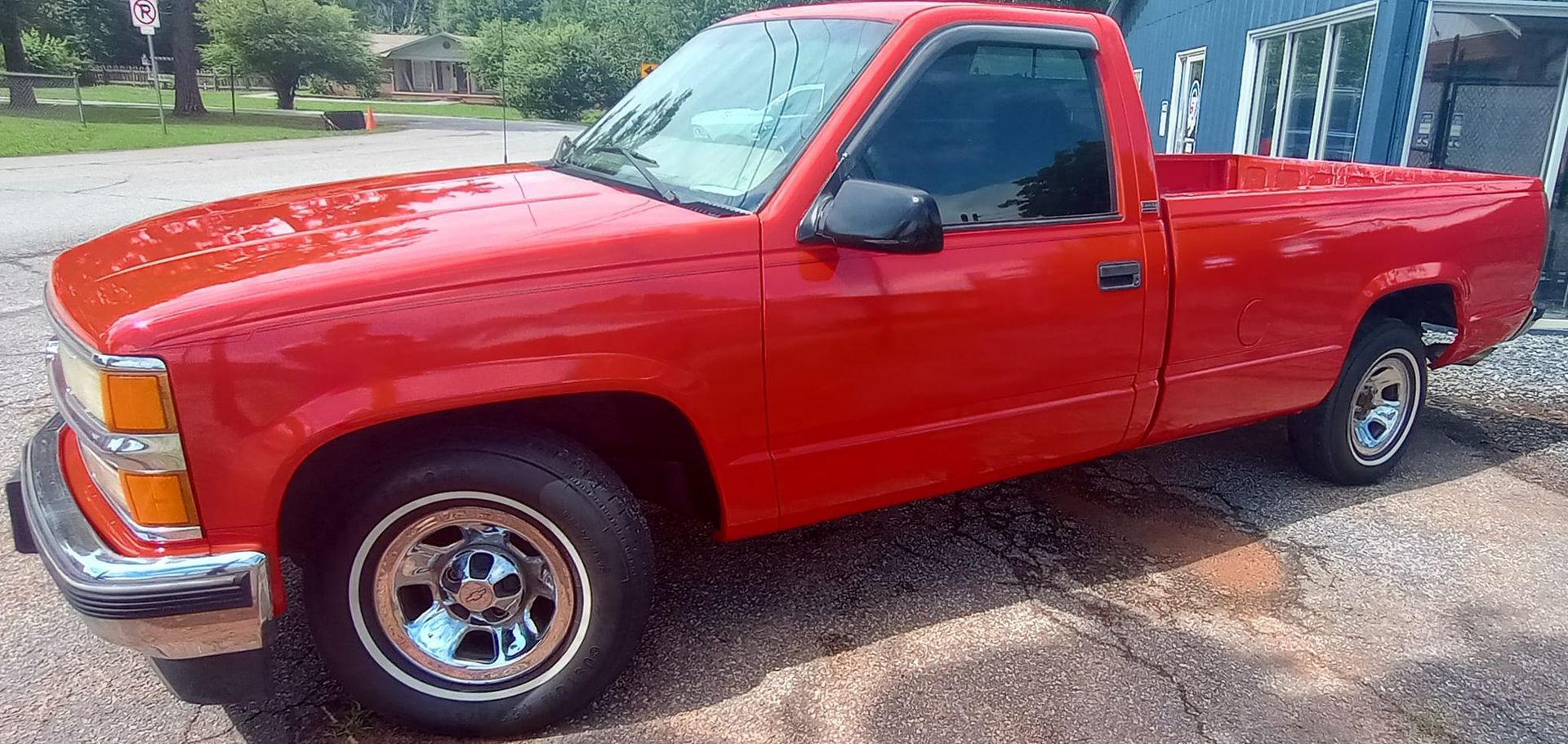 A red truck is parked on the side of the road.