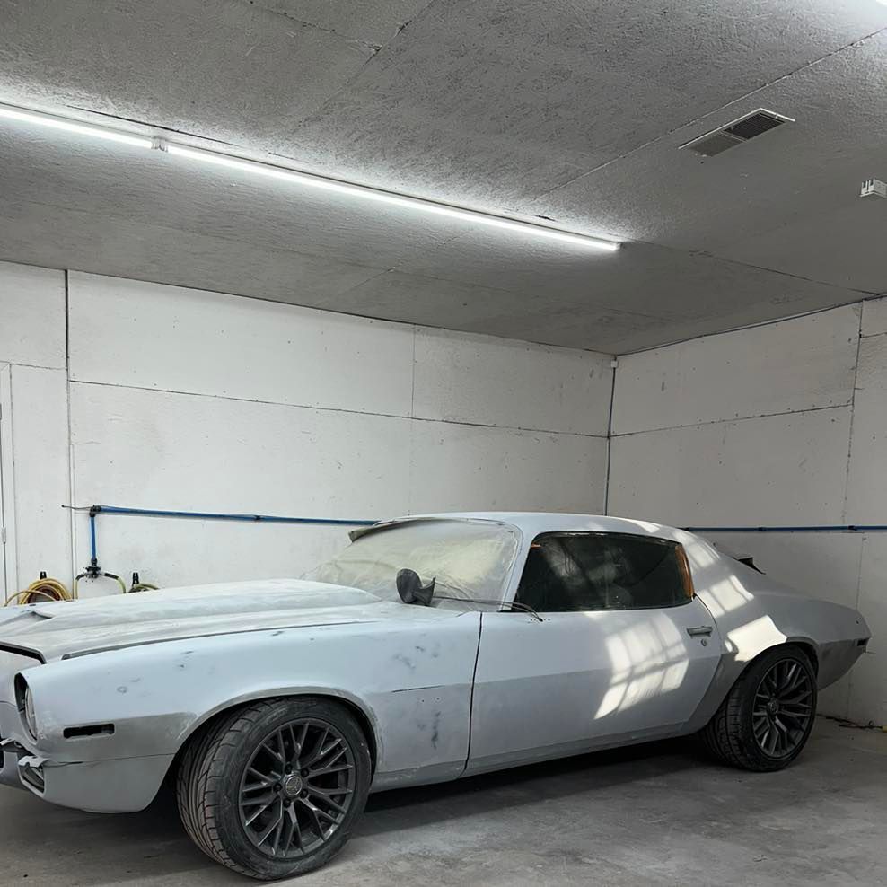 A white car is parked in a garage.