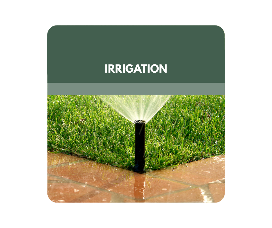 A close up of a sprinkler in a field of flowers.