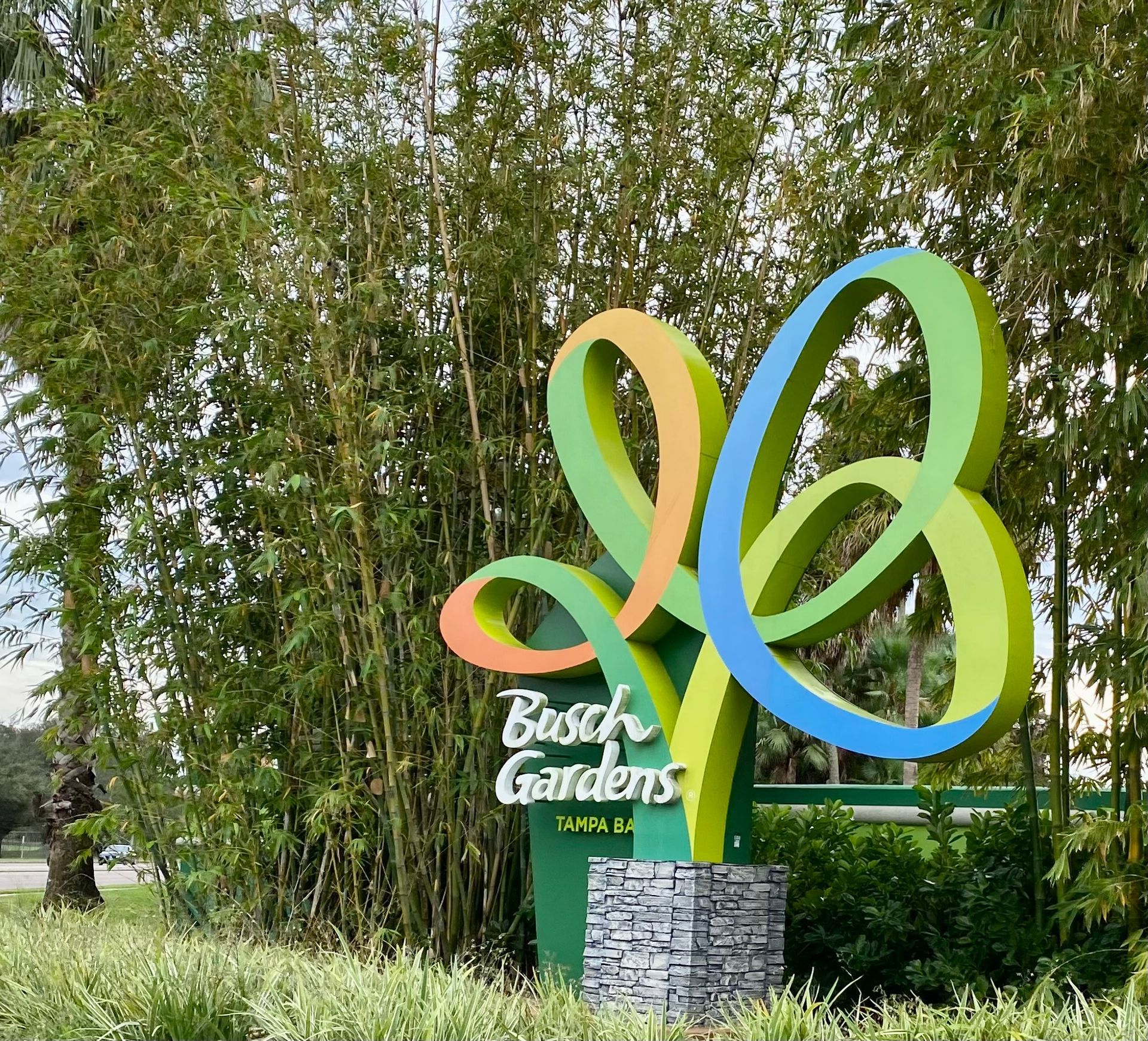 A sign for busch gardens is surrounded by trees-Crowders Landscaping