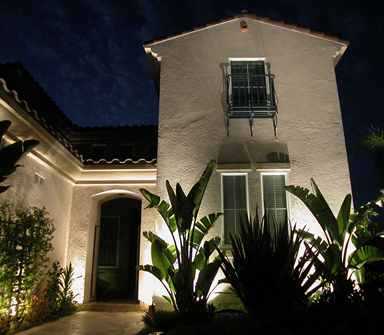 The front of a house is lit up at night