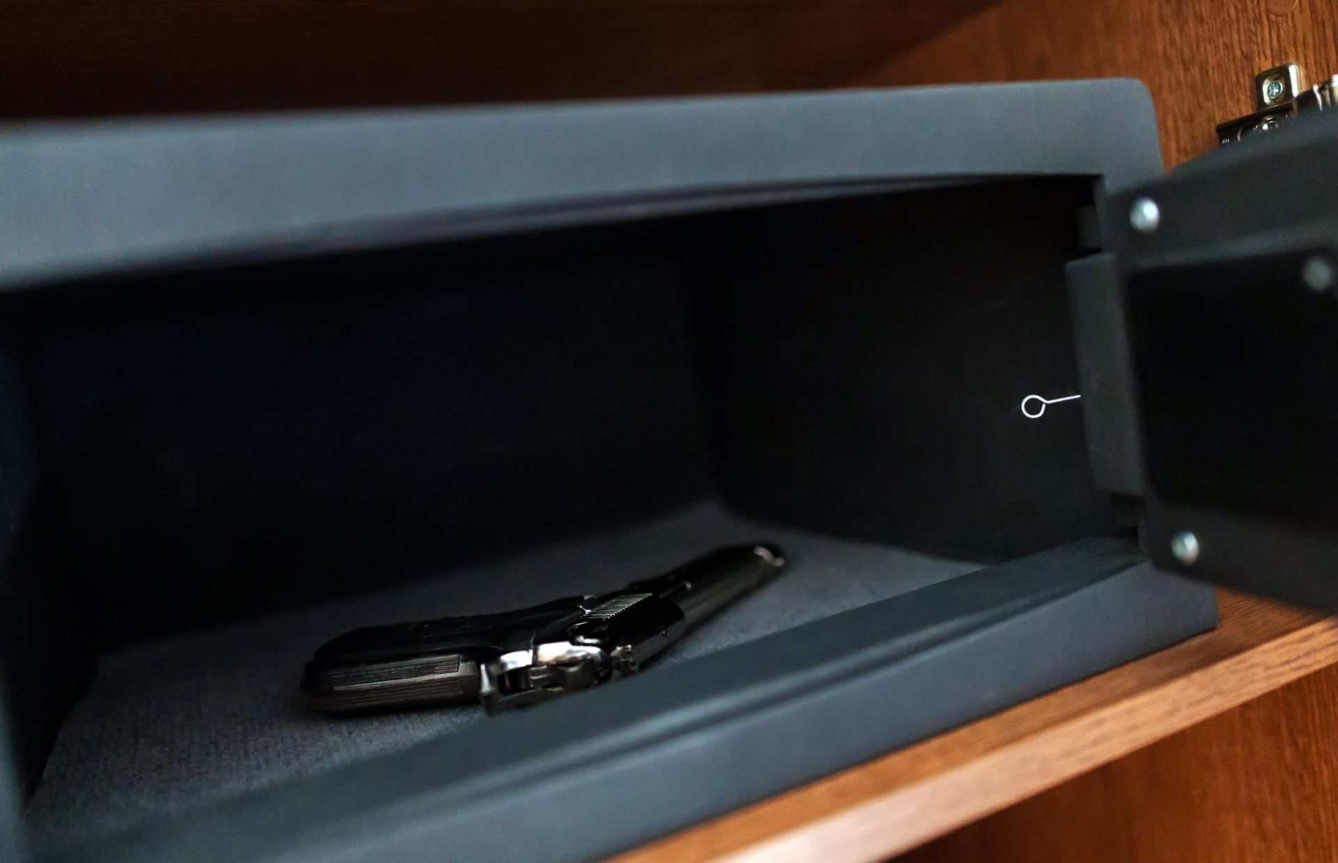 A close up of a safe with a key in it.