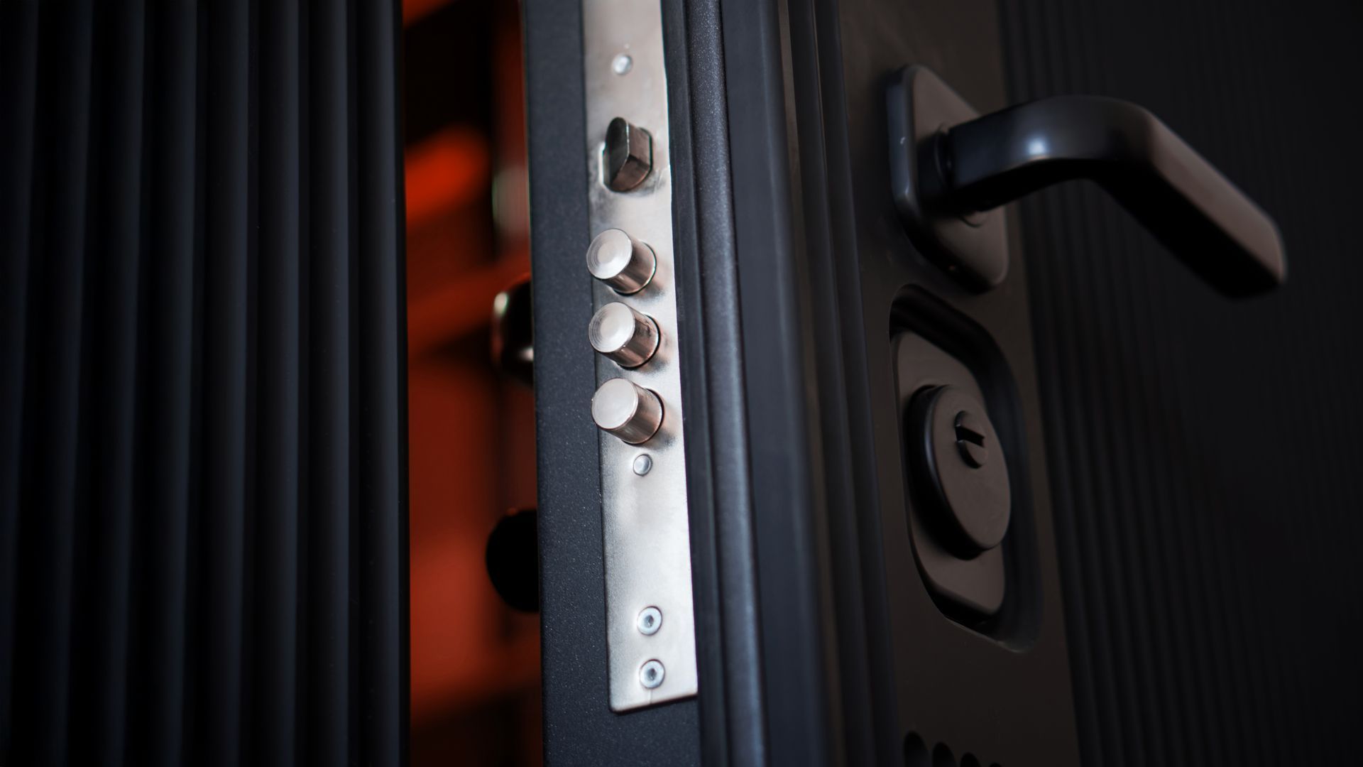 A close up of a door with a handle and a lock.