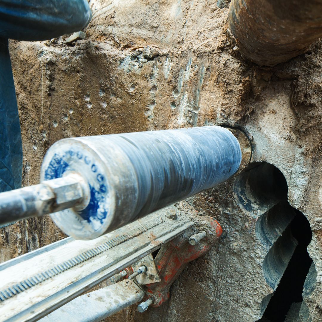 A person is using a machine to drill a hole in the ground