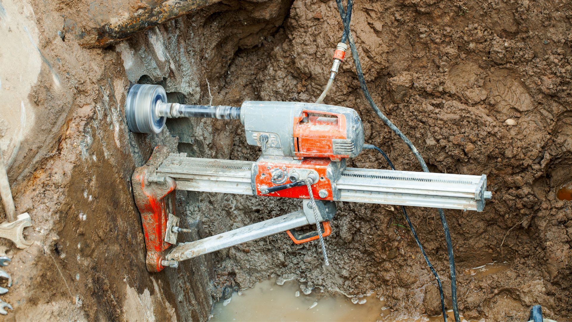 A drill is being used to drill a hole in the ground.