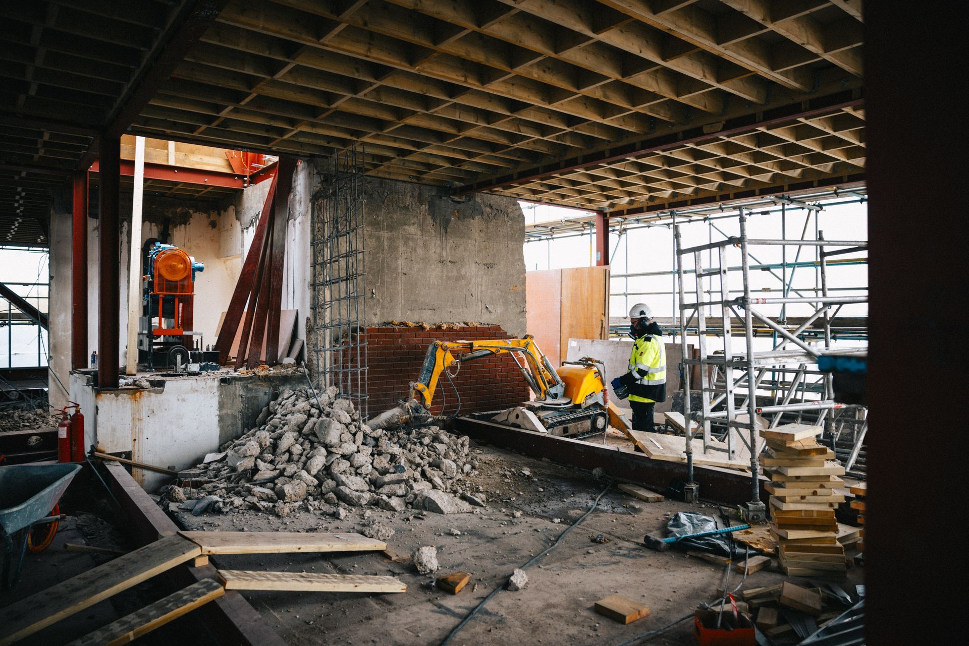 A construction site with a lot of bricks and scaffolding.