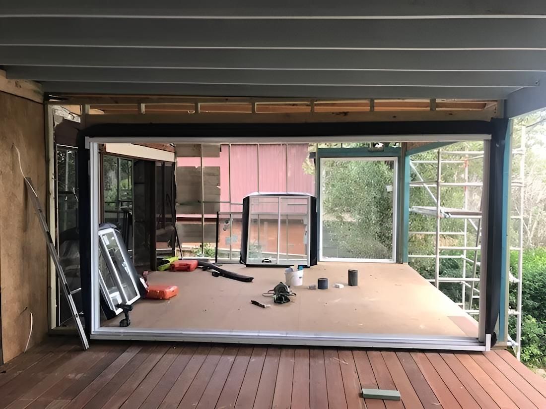 A Room With a Lot of Windows and a Wooden Floor — East Maitland Building In Lake Macquarie, NSW