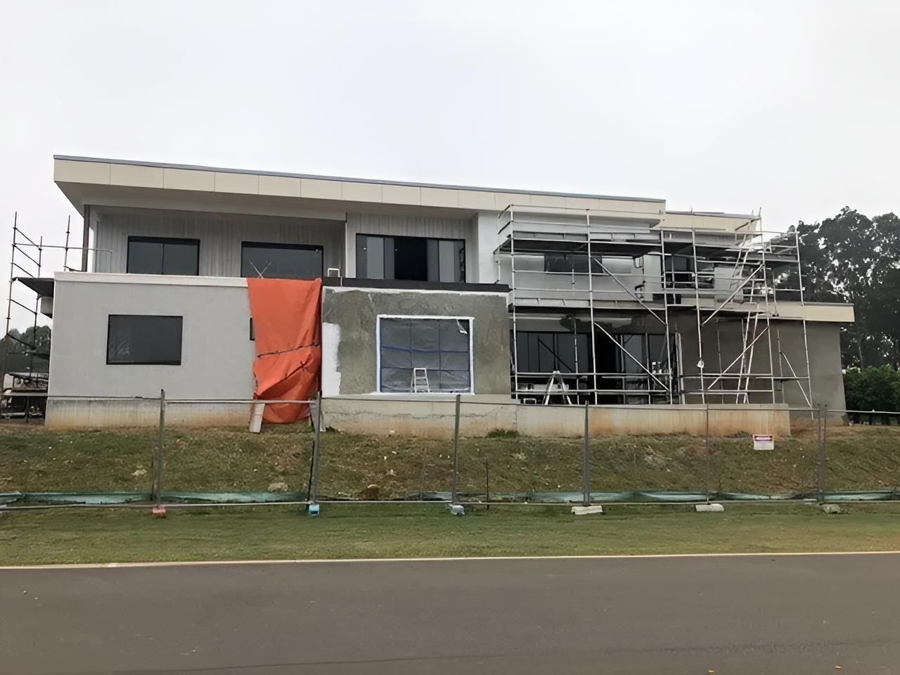 A Large House is Being Built on a Hill Next to a Road — East Maitland Building In Maitland, NSW