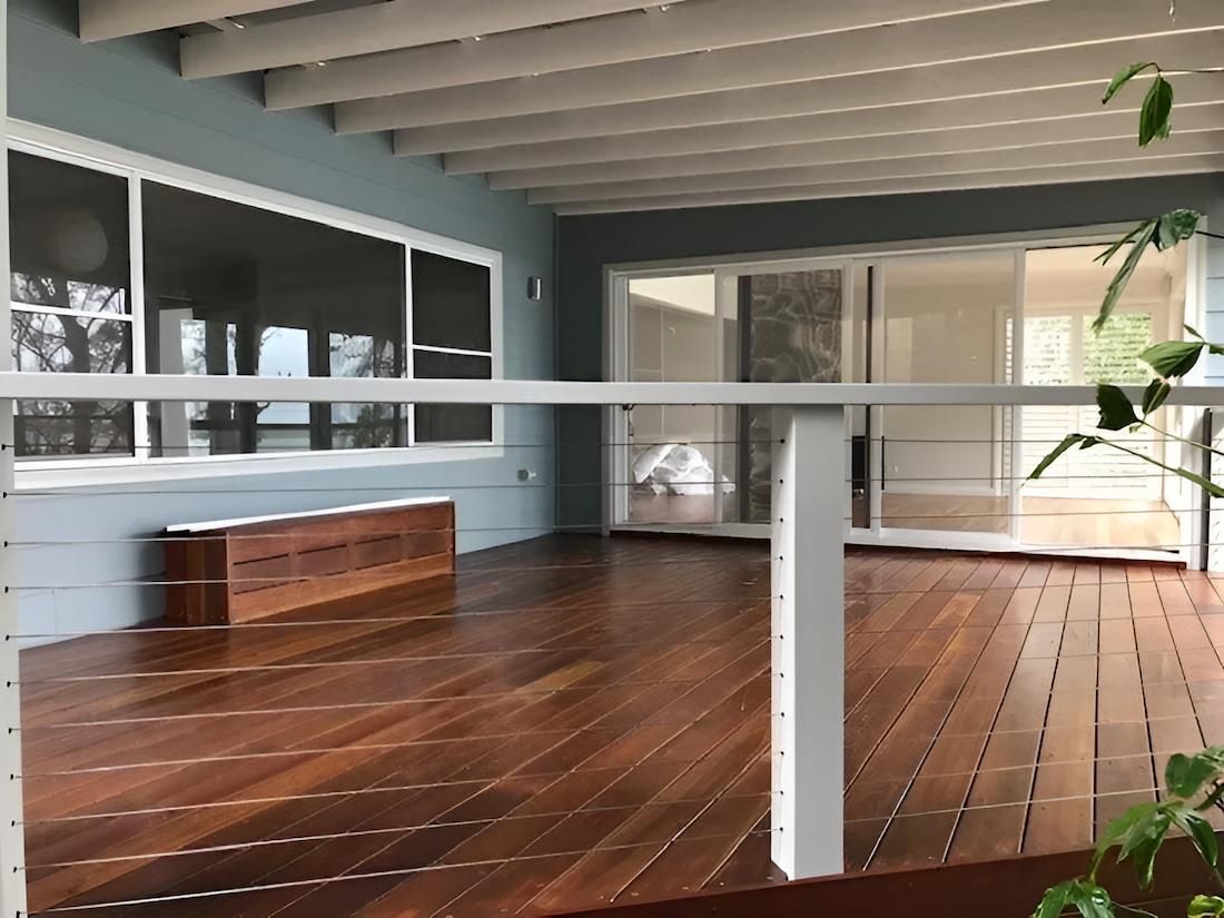 A Wooden Deck With a White Railing and a Bench — East Maitland Building In Tenambit, NSW