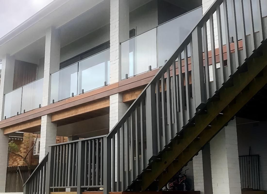 Stairs Leading Up to a Balcony With a Glass Railing — East Maitland Building In Tenambit, NSW