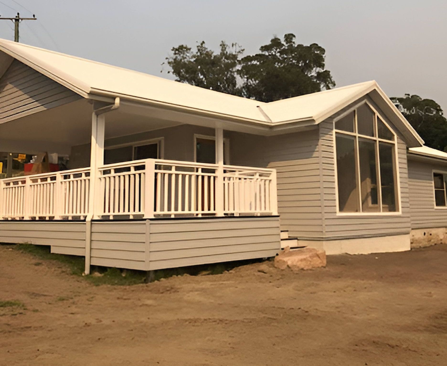 A House With a Large Porch and a White Railing — East Maitland Building In Maitland, NSW