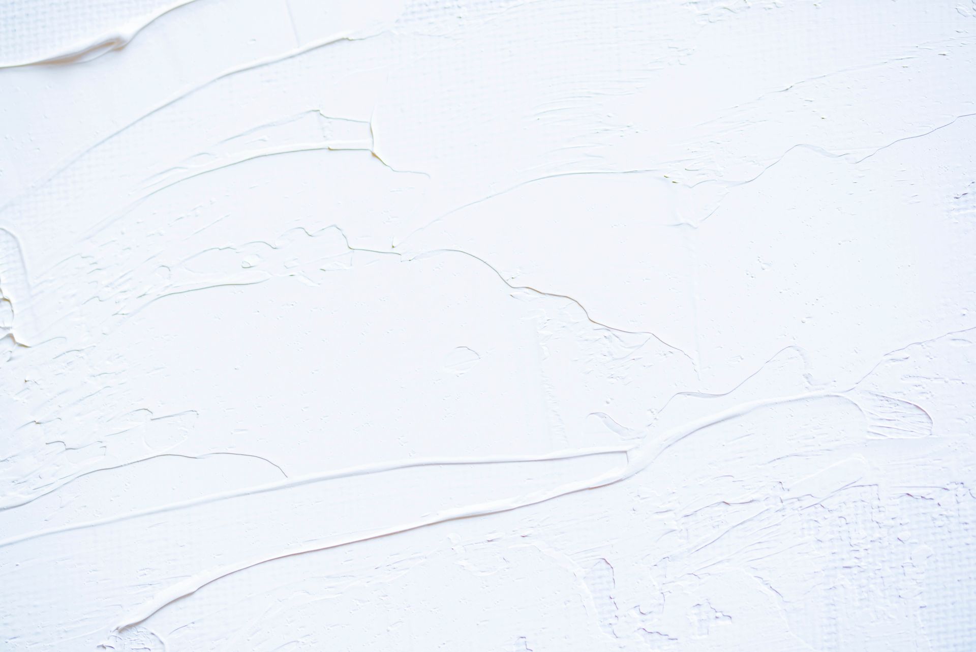 A close up of a white wall with a texture.