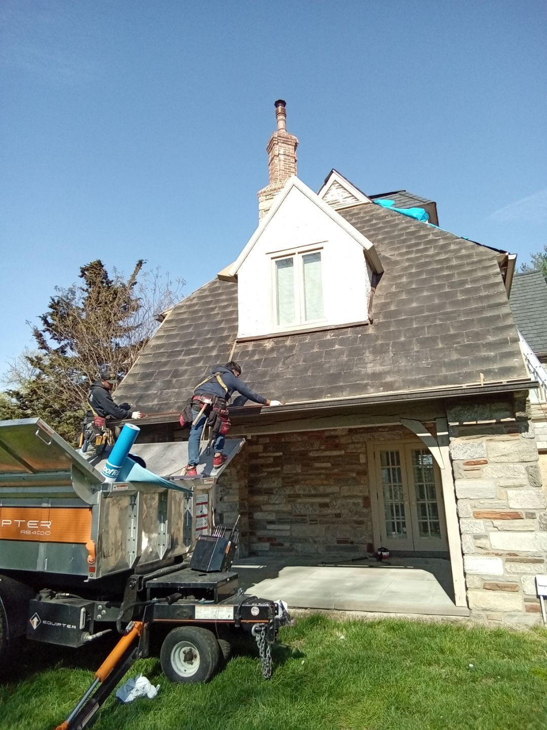 Phot of chimney on the roof of a house in need of repair.
