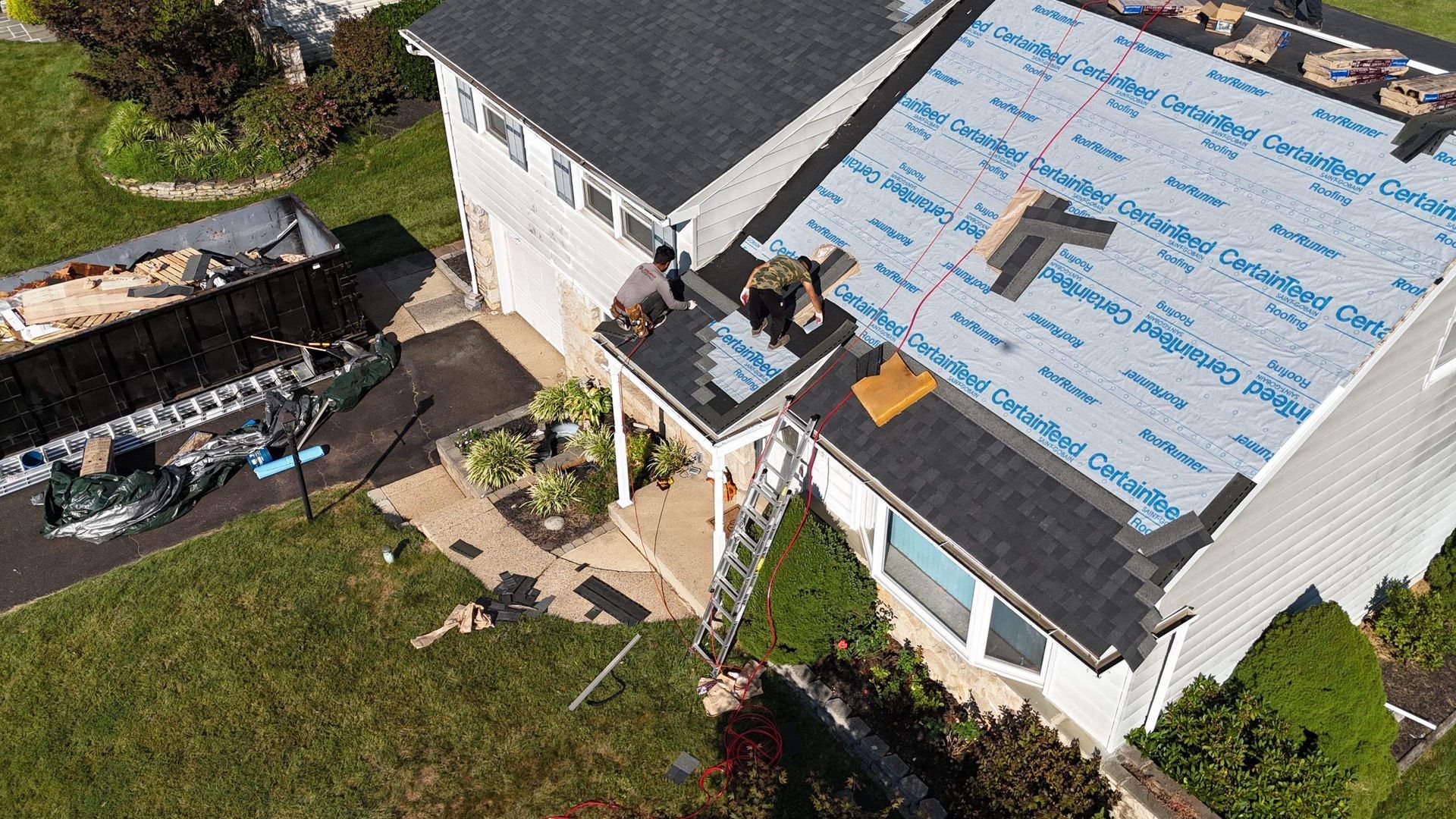 Photo of a house with a roof being replaced by Essential Exteriors