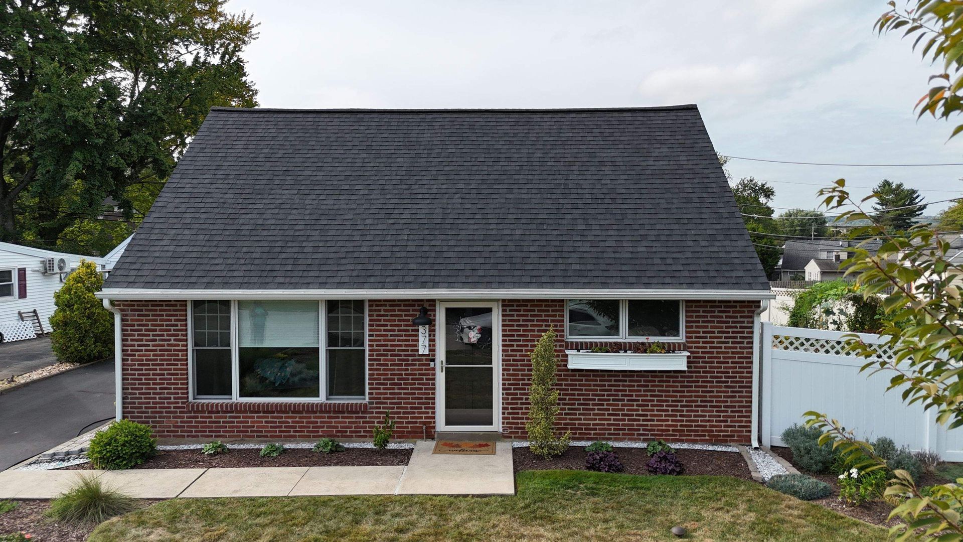 Photo of a house with a new roof installed by Essential Exteriors.