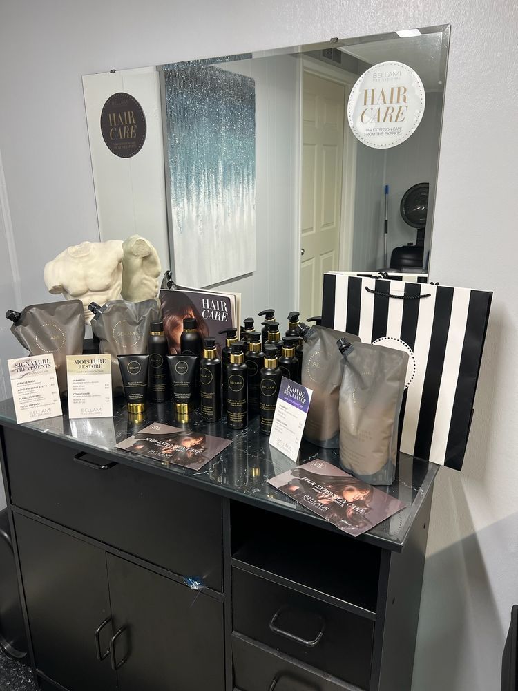 A dresser filled with hair products and a mirror in a salon.