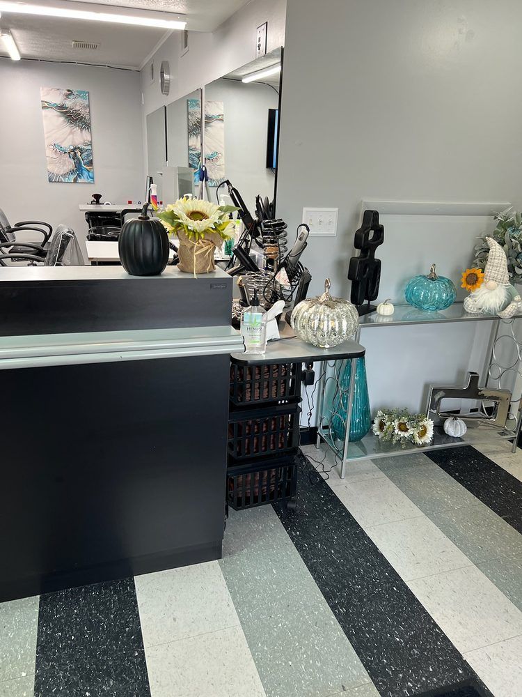 A salon with a black and white striped floor and a black counter.
