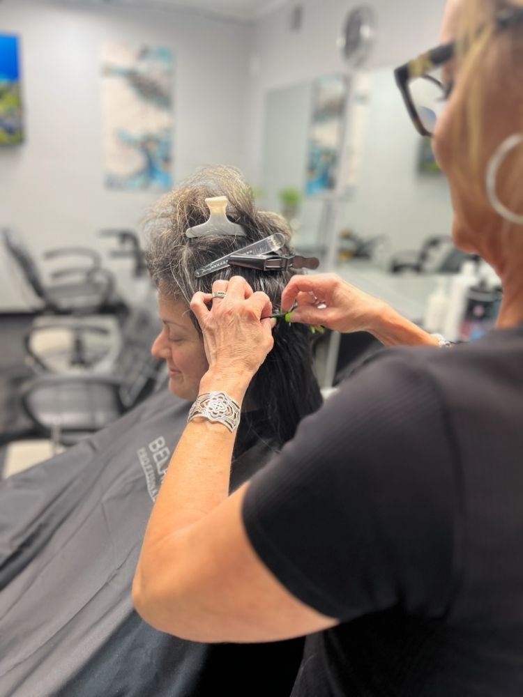 A woman is getting her hair dyed in a salon.
