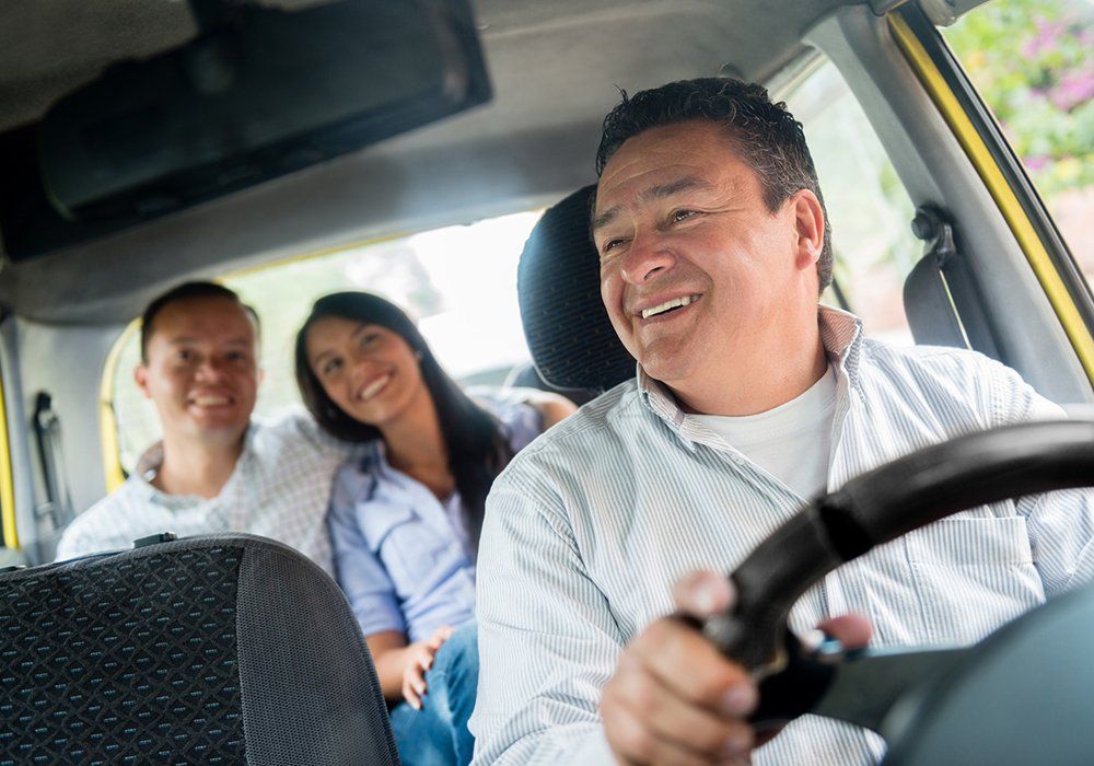 Taxi Driver with Couple Passengers — Metairie, LA — Metry Cab Service