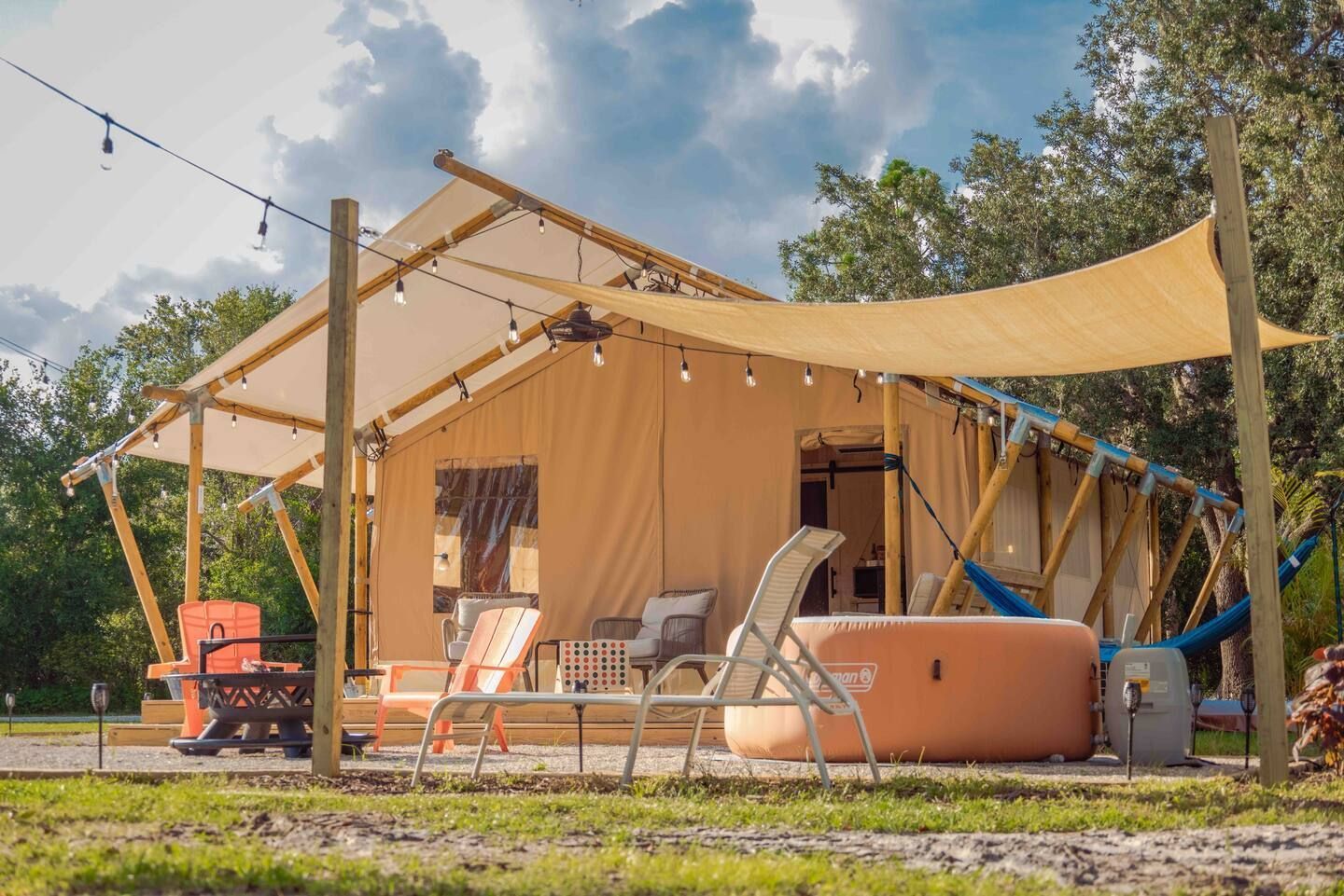 A large tent is sitting in the middle of a grassy field.