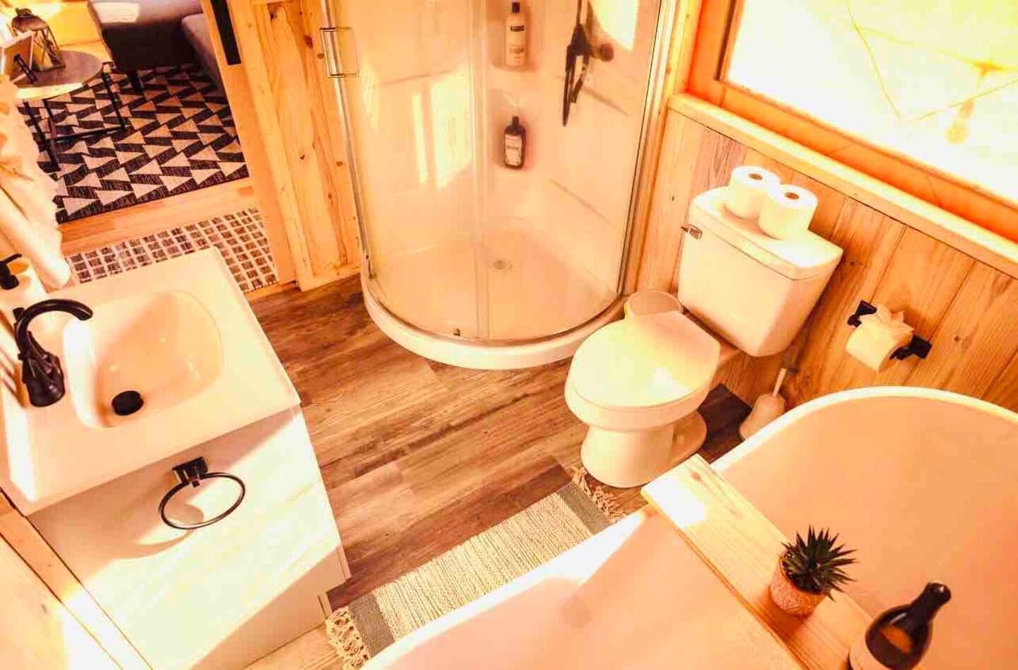 A bathroom with a sink , toilet , shower and bathtub.